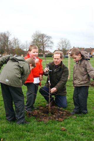 Kids planting a tree at Abbey Park