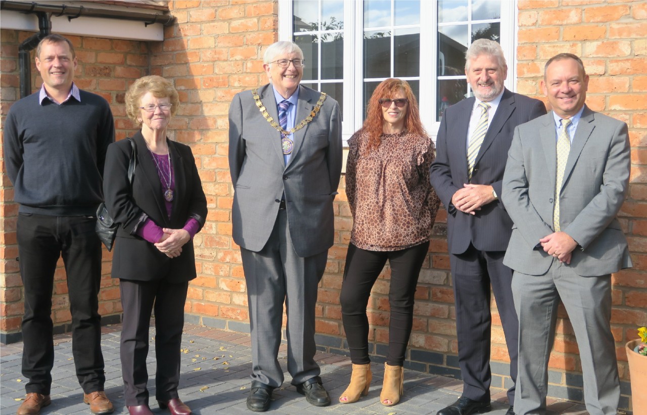 A photo of six people at the opening of the Charlton Village Hall: Nigel Cates, Chairman of Joseph Baker Charity; Eleanor Sinton; Alex Sinton, Chairman of Wychavon District Council; Tracy Perkins, Communities and Engagement Officer at Wychavon District Council; Cllr Tony Rowley, Executive Board Member for Climate Change, Environmental Policy and Regulatory Services at Wychavon District Council; Vic Allison, Chief Executive of Wychavon District Council.