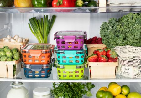Coloured food containers stored in a packed fridge