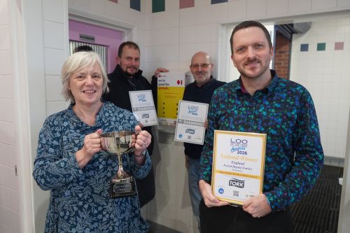 A group of people with certificates in a toilet