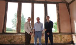 Three people stood in front of a window
