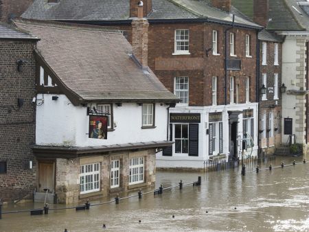Street flooding surrounding public house