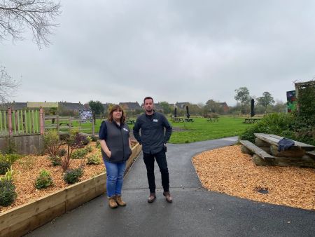 Two people standing on a pathway