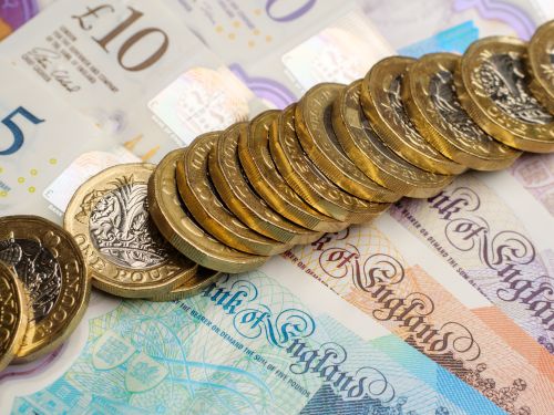 A close up shot of UK pound coins and notes